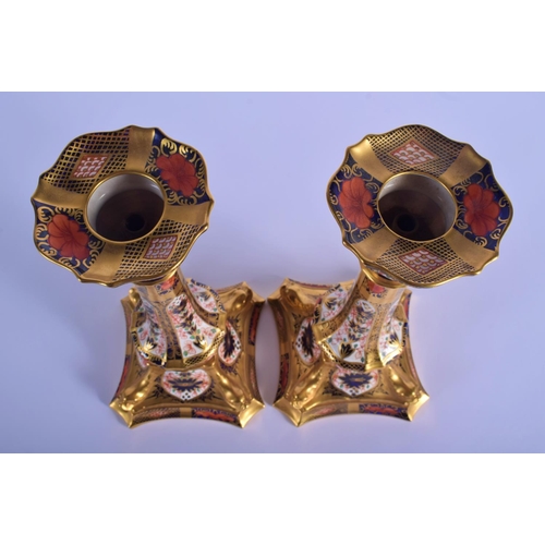 5 - A PAIR OF ROYAL CROWN DERBY IMARI PORCELAIN CANDLESTICKS painted with flowers and vines. 28 cm high.