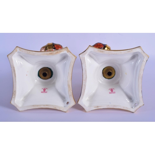 5 - A PAIR OF ROYAL CROWN DERBY IMARI PORCELAIN CANDLESTICKS painted with flowers and vines. 28 cm high.