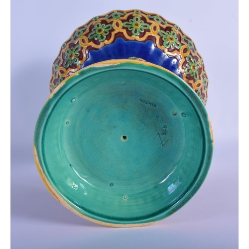 51 - A 19TH MINTON MAJOLICA PEDESTAL DOUPLE PUTTI CENTREPIECE modelled upon a base overlaid with flowers.... 