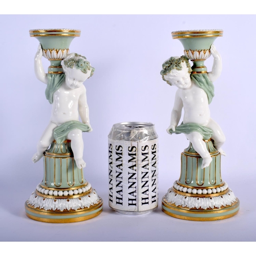 113 - MINTON PAIR OF SEVRES STYLE CHERUB CELADON CANDLESTICKS WITH GILT HIGHLIGHTS C.1880.24cm high (Pr)