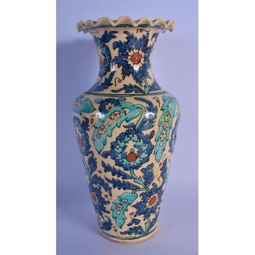 12 - A MIDDLE EASTERN FAIENCE IZNIK STYLE POTTERY VASE painted with flowers. 28 cm high.