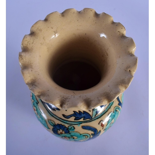 12 - A MIDDLE EASTERN FAIENCE IZNIK STYLE POTTERY VASE painted with flowers. 28 cm high.