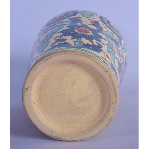 12 - A MIDDLE EASTERN FAIENCE IZNIK STYLE POTTERY VASE painted with flowers. 28 cm high.