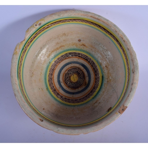 16 - A 17TH/18TH CENTURY SOUTH EUROPEAN FAIENCE GLAZED BOWL painted with sparse foliage. 24 cm x 12 cm.