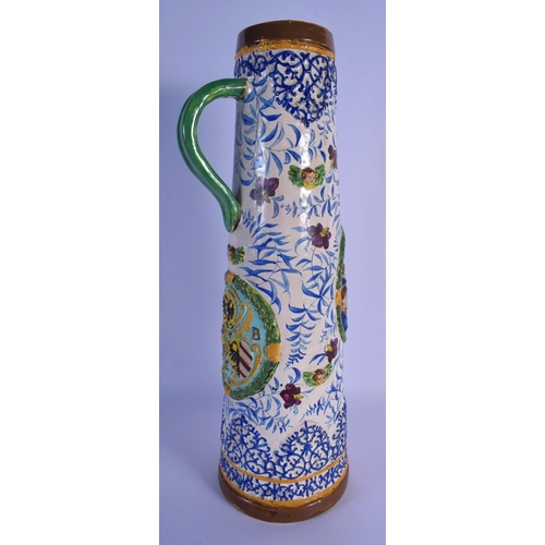 24 - A RARE 18TH/19TH CENTURY EUROPEAN TIN GLAZED POTTERY JUG STEIN painted with figures in relief and an... 