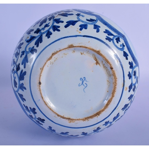 25 - A DUTCH DELFT BLUE AND WHITE GLOBULAR VASE painted with boats within panels of flowers. 22 cm x 13 c... 