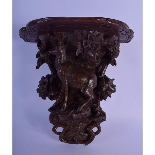 303 - A 19TH CENTURY BAVARIAN BLACK FOREST WALL BRACKET modelled as a deer under foliage. 27 cm x 22 cm.