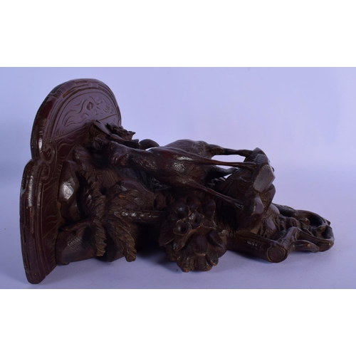 303 - A 19TH CENTURY BAVARIAN BLACK FOREST WALL BRACKET modelled as a deer under foliage. 27 cm x 22 cm.