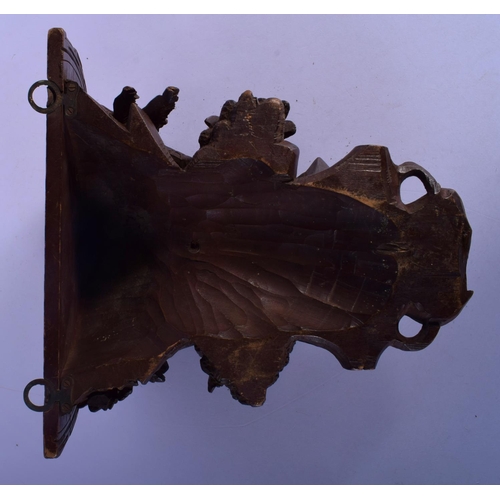 303 - A 19TH CENTURY BAVARIAN BLACK FOREST WALL BRACKET modelled as a deer under foliage. 27 cm x 22 cm.