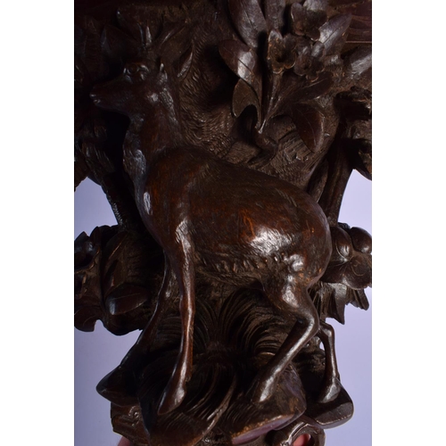 303 - A 19TH CENTURY BAVARIAN BLACK FOREST WALL BRACKET modelled as a deer under foliage. 27 cm x 22 cm.