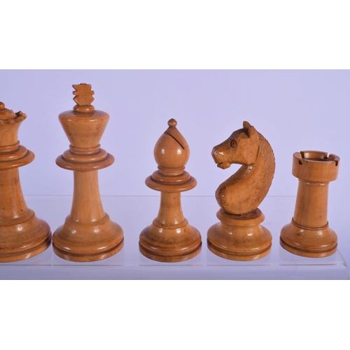 320 - AN EARLY 20TH CENTURY BOXWOOD AND CARVED WOOD CHESS SET. Largest piece 8 cm high. (qty)