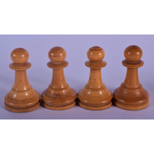 320 - AN EARLY 20TH CENTURY BOXWOOD AND CARVED WOOD CHESS SET. Largest piece 8 cm high. (qty)