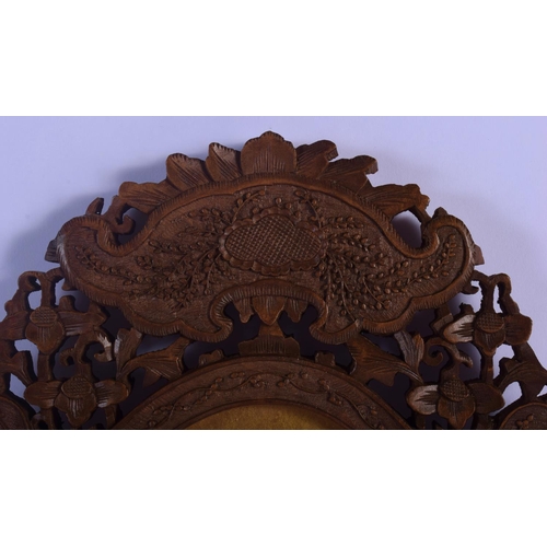 324 - A 19TH CENTURY INDIAN MIDDLE EASTERN CARVED SANDALWOOD FRAME decorated with flowers and vines. 30 cm... 