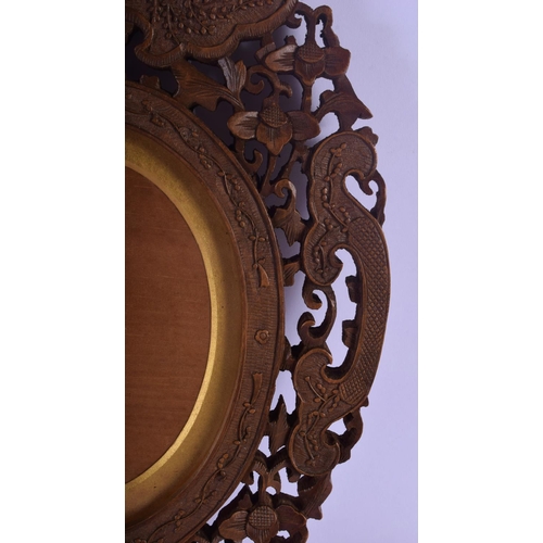 324 - A 19TH CENTURY INDIAN MIDDLE EASTERN CARVED SANDALWOOD FRAME decorated with flowers and vines. 30 cm... 