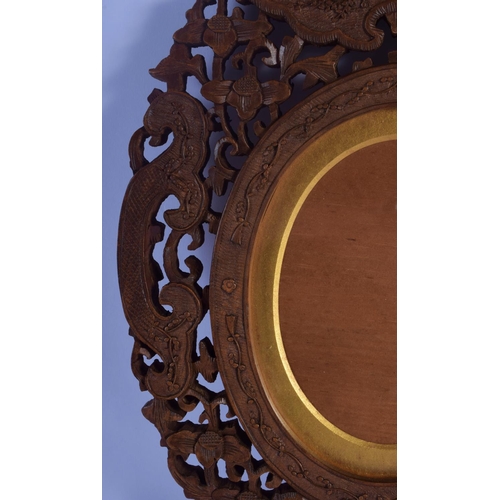 324 - A 19TH CENTURY INDIAN MIDDLE EASTERN CARVED SANDALWOOD FRAME decorated with flowers and vines. 30 cm... 