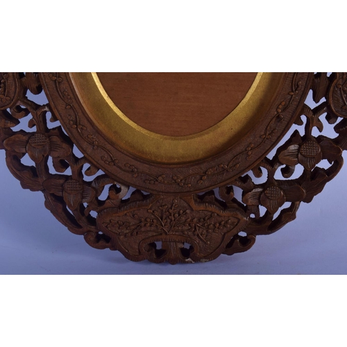 324 - A 19TH CENTURY INDIAN MIDDLE EASTERN CARVED SANDALWOOD FRAME decorated with flowers and vines. 30 cm... 