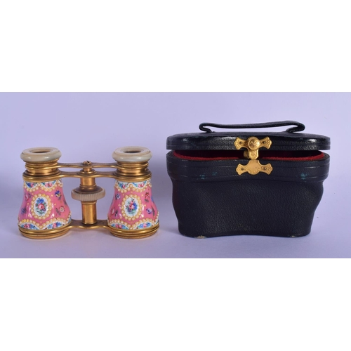 329 - A PAIR OF EARLY 20TH CENTURY EUROPEAN ENAMELLED OPERA GLASSES painted with flowers. 9 cm x 7 cm exte... 