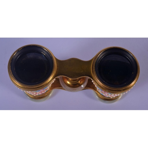 329 - A PAIR OF EARLY 20TH CENTURY EUROPEAN ENAMELLED OPERA GLASSES painted with flowers. 9 cm x 7 cm exte... 