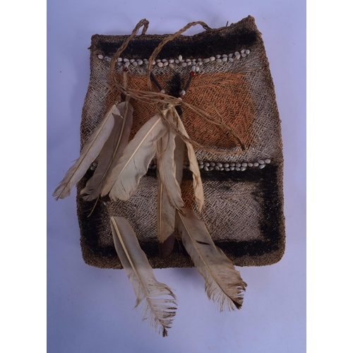 336 - AN EARLY 20TH CENTURY TRIBAL FEATHER MOUNTED MEDICINE BAG decorated with nuts. 34 cm x 26 cm.