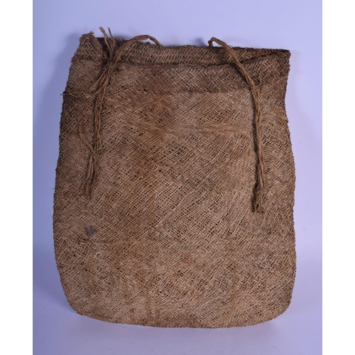 336 - AN EARLY 20TH CENTURY TRIBAL FEATHER MOUNTED MEDICINE BAG decorated with nuts. 34 cm x 26 cm.