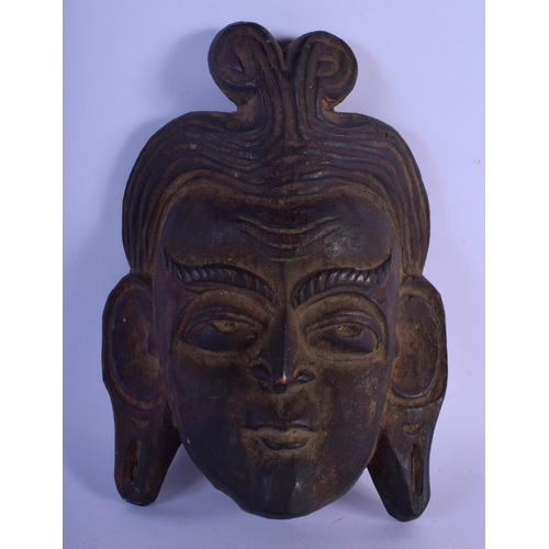 337 - A 19TH CENTURY MIDDLE EASTERN ASIAN CARVED WOOD MASK depicting a long eared male. 25 cm x 15 cm.