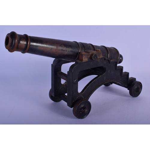 343 - A MID 19TH CENTURY CONTINENTAL CAST IRON DESK CANNON on a rolling frame. 30 cm x 18 cm.