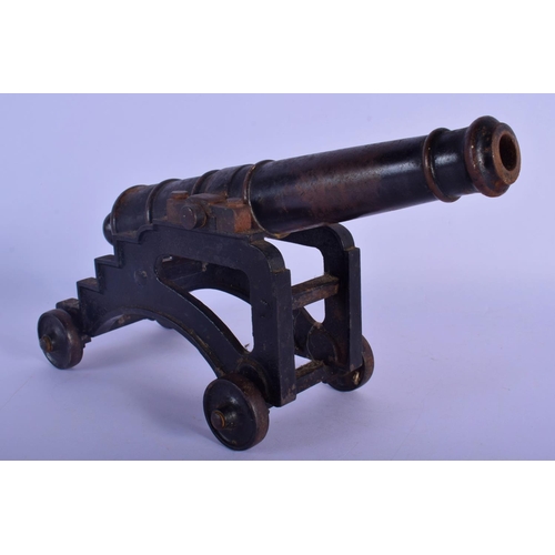 343 - A MID 19TH CENTURY CONTINENTAL CAST IRON DESK CANNON on a rolling frame. 30 cm x 18 cm.