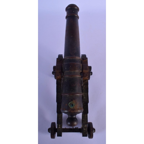 343 - A MID 19TH CENTURY CONTINENTAL CAST IRON DESK CANNON on a rolling frame. 30 cm x 18 cm.