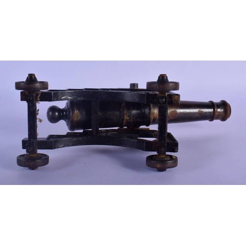 343 - A MID 19TH CENTURY CONTINENTAL CAST IRON DESK CANNON on a rolling frame. 30 cm x 18 cm.