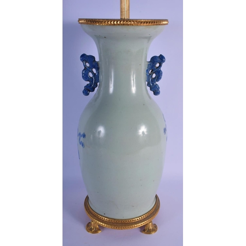 350 - A 19TH CENTURY CHINESE TWIN HANDLED BLUE AND WHITE CELADON VASE converted to a lamp, painted with fl... 