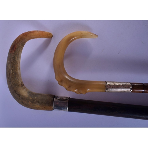 352 - A 19TH CENTURY MIDDLE EASTERN SILVER MOUNTED RHINOCEROS HORN CANE and a similar parasol. Largest 88 ... 