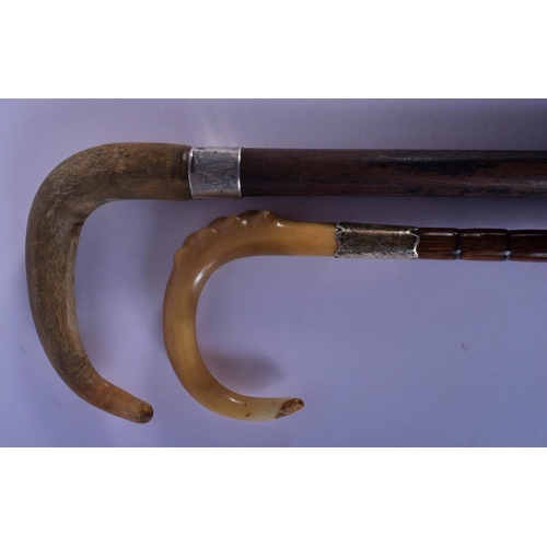 352 - A 19TH CENTURY MIDDLE EASTERN SILVER MOUNTED RHINOCEROS HORN CANE and a similar parasol. Largest 88 ... 