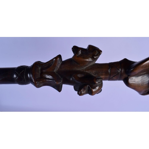 355 - A VINTAGE AFRICAN TRIBAL CARVED WOOD MONKEY SHOOTING STICK. 90 cm long.
