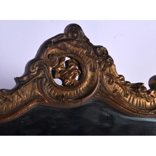 363 - A VINTAGE COUNTRY HOUSE GILTWOOD SCROLLING STRUT MIRROR. 52 cm x 42 cm.