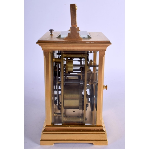 378 - AN ANTIQUE REPEATING BRASS CARRIAGE CLOCK with silver overlaid dial. 18 cm high inc handle.