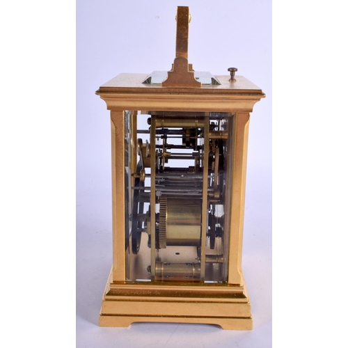 378 - AN ANTIQUE REPEATING BRASS CARRIAGE CLOCK with silver overlaid dial. 18 cm high inc handle.