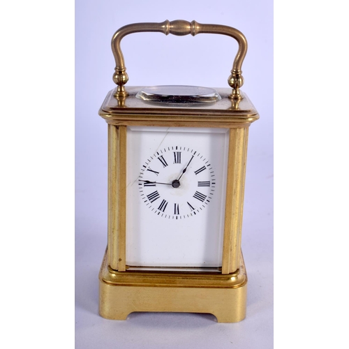380 - A CASED MINIATURE ANTIQUE BRASS CARRIAGE CLOCK. 8.75 cm high inc handle.