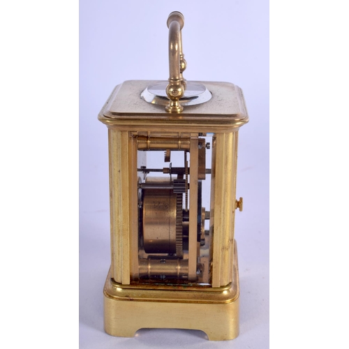 380 - A CASED MINIATURE ANTIQUE BRASS CARRIAGE CLOCK. 8.75 cm high inc handle.