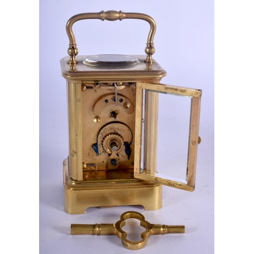 380 - A CASED MINIATURE ANTIQUE BRASS CARRIAGE CLOCK. 8.75 cm high inc handle.