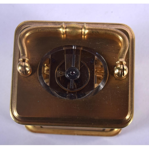 380 - A CASED MINIATURE ANTIQUE BRASS CARRIAGE CLOCK. 8.75 cm high inc handle.