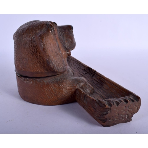 389 - A 19TH CENTURY BAVARIAN BLACK FOREST CARVED WOOD DESK STAND formed as a dog head with inkwell and pe... 