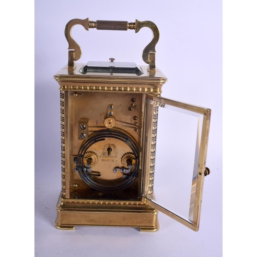 391 - A FINE REPEATING BRASS CARRIAGE CLOCK with well decorated floral face. 18.5 cm high inc handle.
