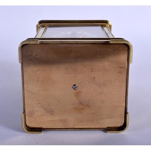 391 - A FINE REPEATING BRASS CARRIAGE CLOCK with well decorated floral face. 18.5 cm high inc handle.