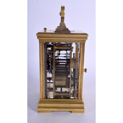 392 - A FRENCH REPEATING BRASS CARRIAGE CLOCK with enamelled dial. 15 cm high inc handle.