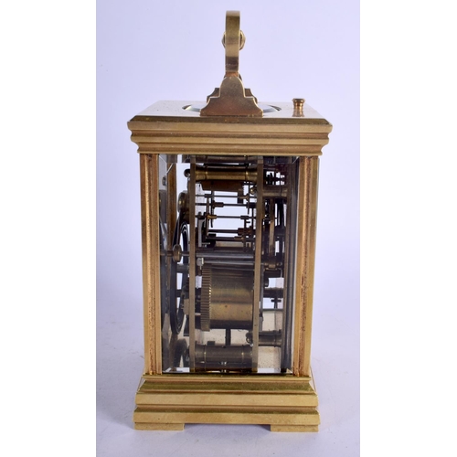392 - A FRENCH REPEATING BRASS CARRIAGE CLOCK with enamelled dial. 15 cm high inc handle.