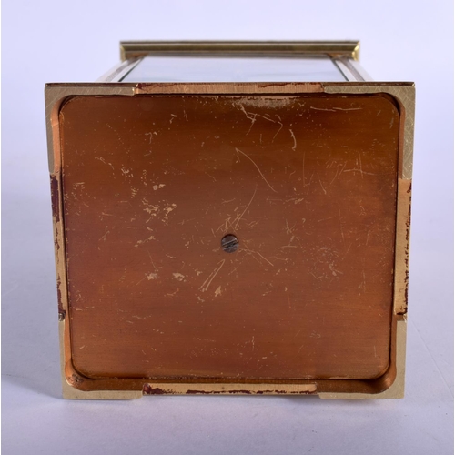 392 - A FRENCH REPEATING BRASS CARRIAGE CLOCK with enamelled dial. 15 cm high inc handle.