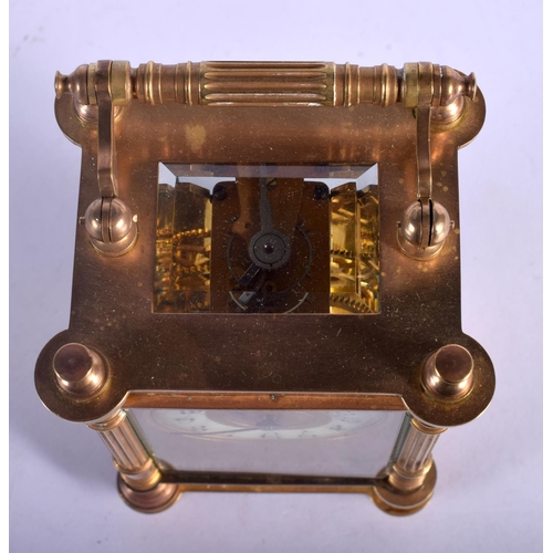 393 - A FRENCH BRASS CARRIAGE CLOCK with circular enamelled dial. 15 cm high.