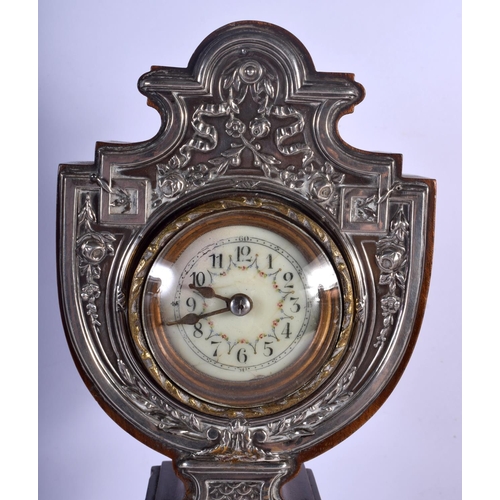 394 - AN ANTIQUE ENGLISH SILVER OVERLAID NEO CLASSICAL MANTEL CLOCK decorated with flowers. 40 cm high.