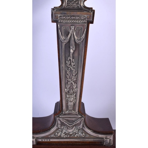 394 - AN ANTIQUE ENGLISH SILVER OVERLAID NEO CLASSICAL MANTEL CLOCK decorated with flowers. 40 cm high.