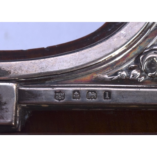 394 - AN ANTIQUE ENGLISH SILVER OVERLAID NEO CLASSICAL MANTEL CLOCK decorated with flowers. 40 cm high.